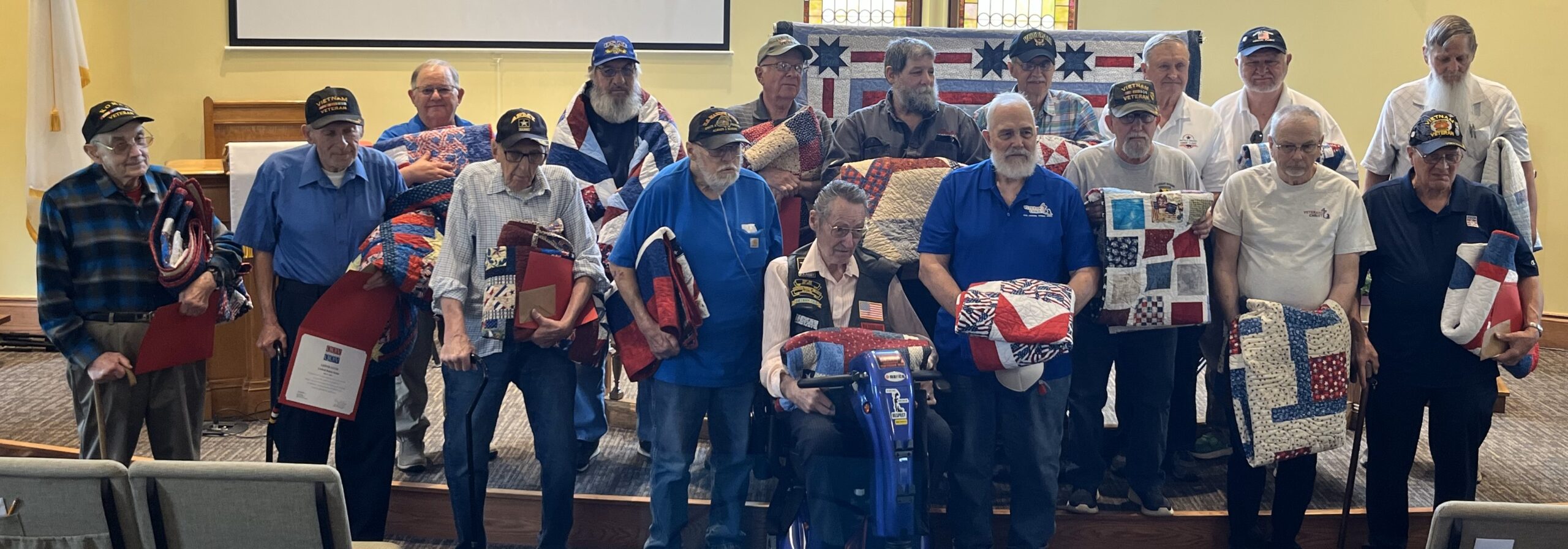 https://ogden_images.s3.amazonaws.com/www.observertoday.com/images/2025/07/18202456/Quilts-of-Valor-veterans-1-scaled-1.jpg